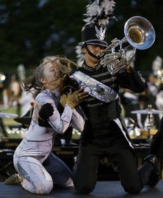 a man and woman playing musical instruments on stage