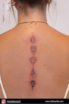 the back of a woman's neck with different tattoos on her upper and lower back