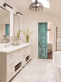 a large bathroom with two sinks and a bathtub next to a doorway that leads to another room