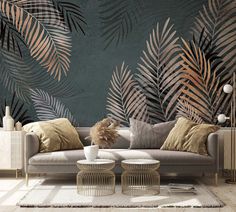 a living room with palm leaves on the wall and two tables in front of it