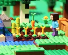 a close up of a lego scene with people and trees