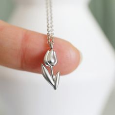 "Beautiful and lovely Tulip charm necklace. Made of a matte finish Tulip charm with a skinny rhodium plated brass chain. Soft and simple. Great for gift, everyday or special occasions.  Your item will ship in a gift box. Please feel free to contact me if you have any questions. ♥ Length  14\" - 20\" chain ♥ Tulip charm   3/8\" x 5/8\" long ♥ Rhodium plated over brass  ♥  See more Rudiana Accessories  Rudiana.etsy.com" Silver Simple Jewelry, Tulip Jewelry, Informal Dining, Tulip Necklace, Silver Necklace Simple, Diamond Pendants Designs, Necklace Flower, Girly Accessories, Gift Graduation