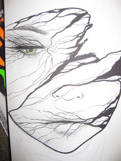 a drawing of a woman's face with green eyes