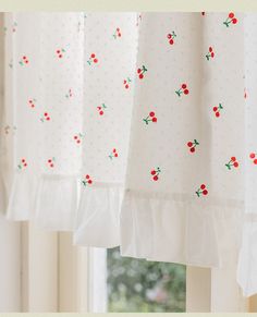 red cherries are on the white curtains in front of a window with polka dots