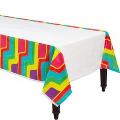 a colorful table cloth on top of a white table