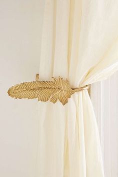 a curtain with a gold leaf on it