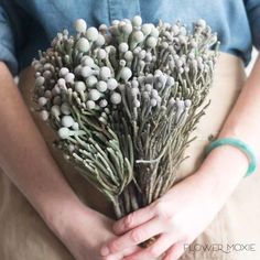 a person holding a bunch of flowers in their hands