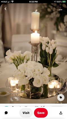 a table setting with candles and flowers on it