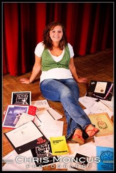 a woman sitting on the floor surrounded by papers