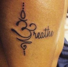 a woman's leg with the word breathe tattooed on her left side ribcage