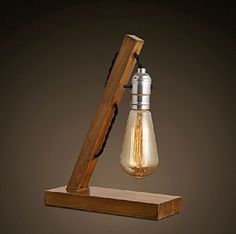 an old fashioned light bulb hanging from a wooden stand with a wood beam attached to it