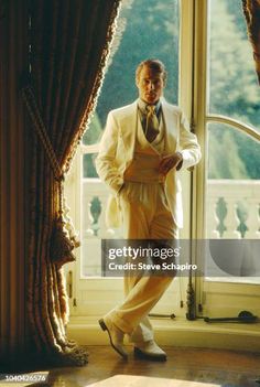 a man standing in front of a window