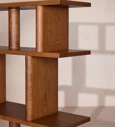 a wooden shelf sitting on top of a tiled floor