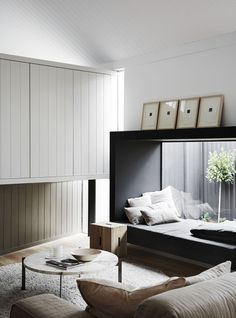 a living room filled with furniture and white walls