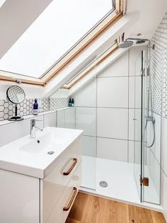 a bathroom with a skylight above the sink