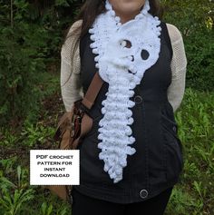 a woman wearing a white crochet scarf with a bear face on the front