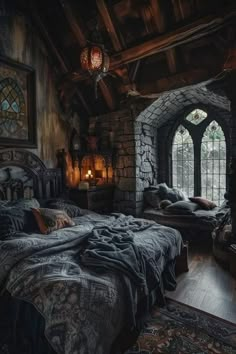 a bedroom with stone walls and an arched window in the corner is lit by candles