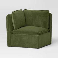 a green chair with two pillows on the back and one arm folded up to it's side