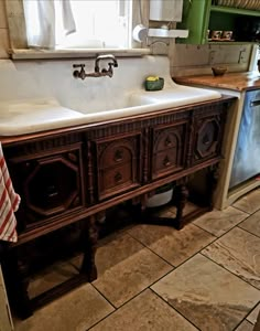 an old fashioned kitchen sink in front of a window