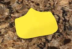 a yellow piece of paper sitting on top of a counter