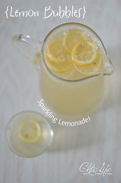 a pitcher filled with lemon bubbles next to two glasses