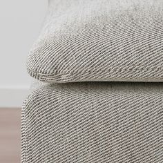 a close up view of the back end of a couch with a pillow on it