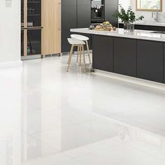 a large kitchen with gray cabinets and white flooring