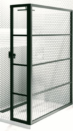 a black and white photo of a metal structure with mesh covering it's sides