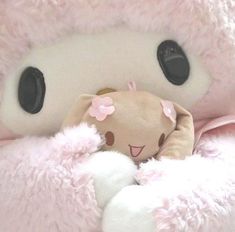 there is a stuffed animal in the pink blanket