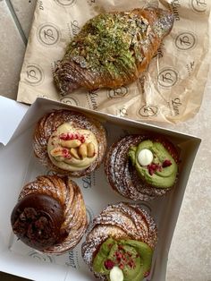 a box filled with assorted pastries on top of a table