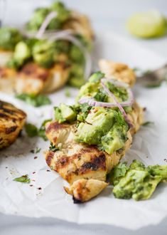 grilled chicken with avocado and red onion garnish on the side