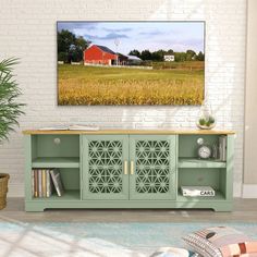 a living room scene with focus on the sideboard and red barn in the background