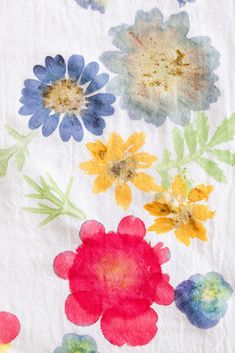 an image of colorful flowers on white fabric