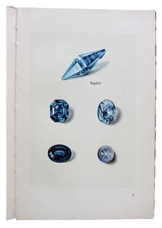 an open book with several different types of stones on the page and in it's center