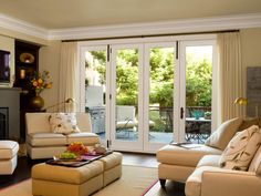 a living room filled with furniture and a fire place in front of a sliding glass door