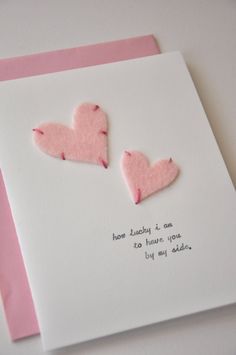 two pink hearts on a white card that says how lucky it is to have you by my side