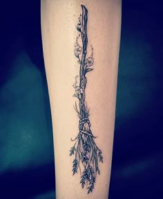 a tattoo on the leg of a woman with flowers and vines growing out of it