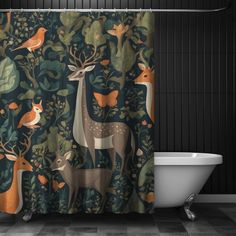 the shower curtain is decorated with deers and birds in an ornate forest pattern, along with a white bathtub