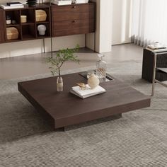 a living room with a coffee table and chairs