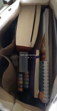 the inside of a purse filled with books