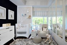 a baby's room is decorated in white and black