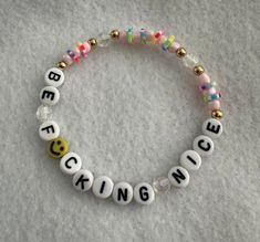 a beaded bracelet that says be kind of nice