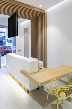 a modern office with white walls and wooden slats