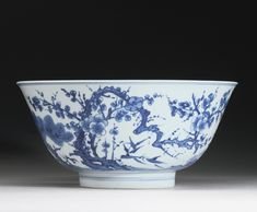 a blue and white bowl sitting on top of a table