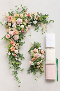 flowers and greenery are arranged on the wall