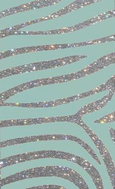 an abstract pattern made up of silver and blue glitters on a light green background