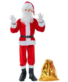 a man dressed as santa claus standing next to a gold bag