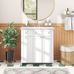 a bathroom with a sink, mirror and plants in the corner on the floor next to it