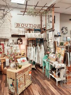 a room filled with lots of different types of furniture and decor on display in front of a window