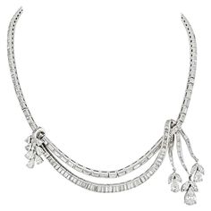 Extravagance is the single word that describes the lustrous Art Deco time period. Abstract designs of geometric shapes are intellectually fused together to create fascinating designs. This quintessential dazzling necklace is crafted in platinum and is mounted with baguette, pear cuts, and marquise cut diamonds. Diamonds: 10 Pear Cuts, 6 Marquise Cuts, 184 Baguette Cuts Quality: G-H color, VS-SI clarity Length: 16 inches with 1.5 inch drop. Luxury Platinum Art Deco Diamond Necklace, Diamond Collar, Platinum Necklace, Art Deco Aesthetic, The Jazz Age, Gold Diamond Earrings Studs, Pearl Drop Necklace, Gold Diamond Studs, Art Deco Bracelet